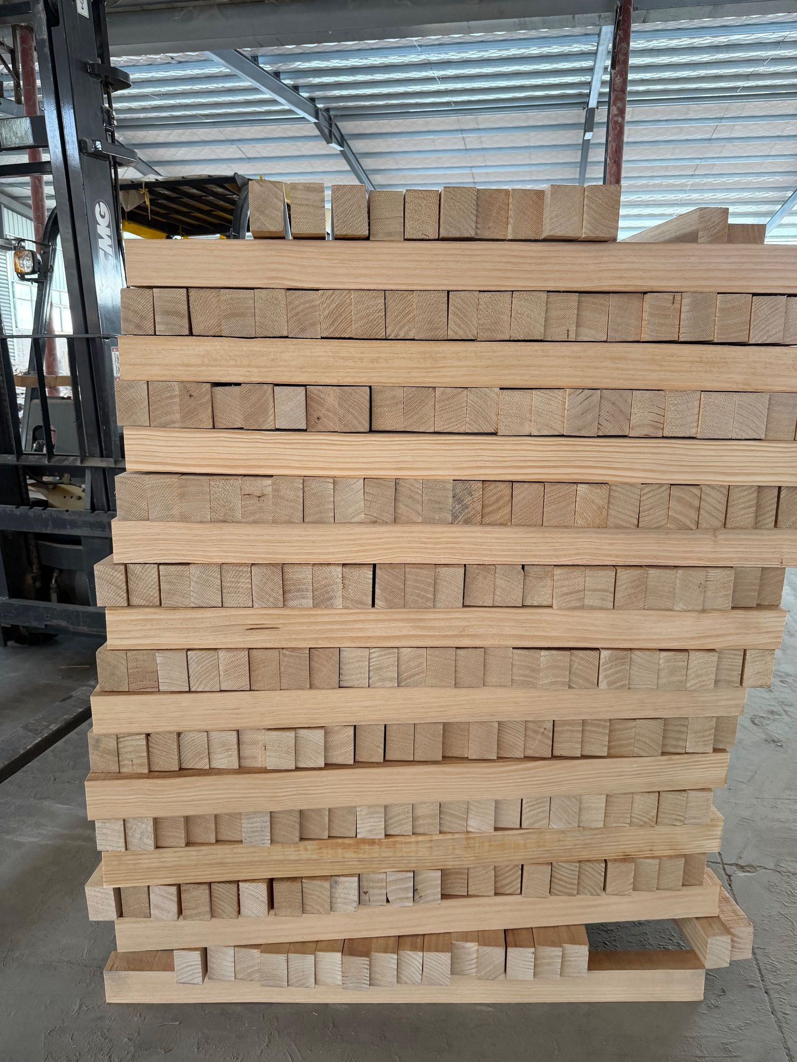 Timber staged for sauna cabin production at the partner base